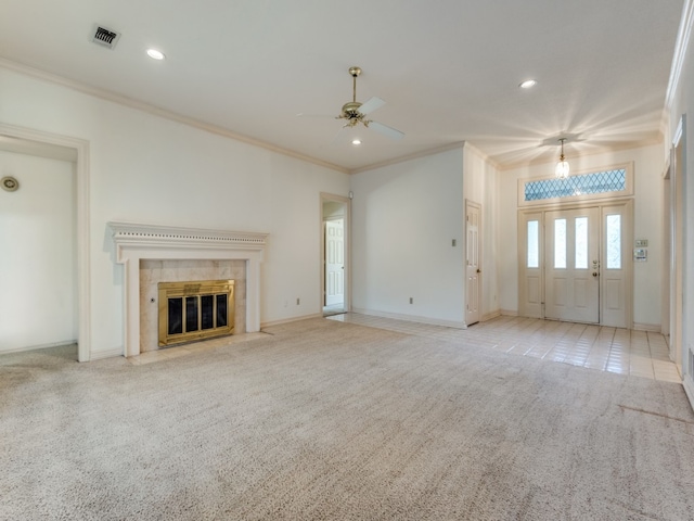 unfurnished living room with crown molding, ceiling fan with notable chandelier, light carpet, and a fireplace