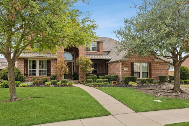 view of front of property with covered porch and a front lawn