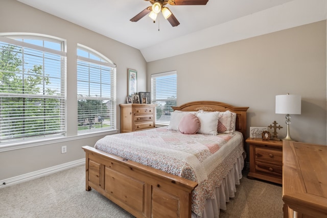 carpeted bedroom featuring ceiling fan and vaulted ceiling