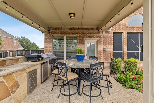 view of patio / terrace featuring a grill and exterior kitchen