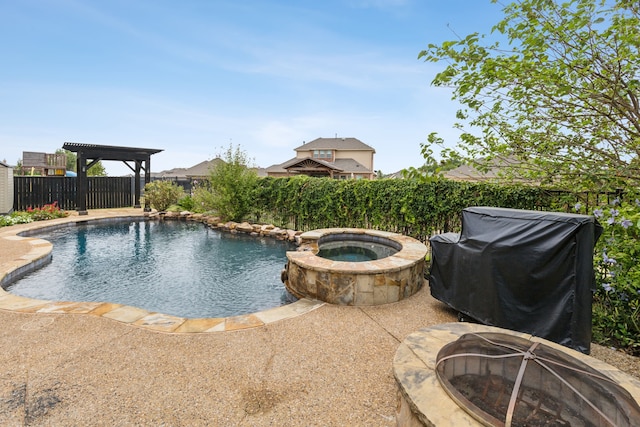 view of swimming pool with a fire pit and an in ground hot tub