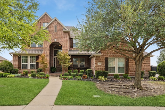 3113 Wimberley Ln, Rockwall, TX 75032 - view of front of home featuring brick siding, a standing seam roof, and a front lawn