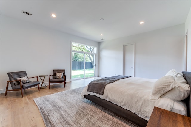 bedroom featuring light wood-type flooring and access to exterior