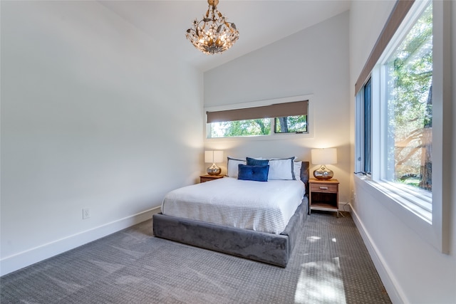 carpeted bedroom featuring a notable chandelier and high vaulted ceiling