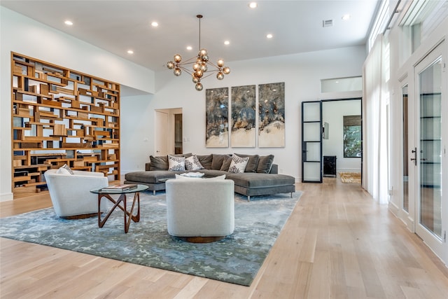 living room featuring an inviting chandelier and light wood-type flooring