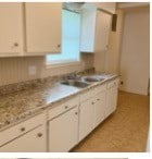 kitchen with sink and white cabinets