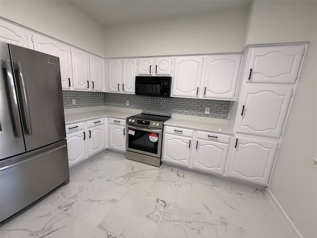 kitchen featuring white cabinetry, appliances with stainless steel finishes, and tasteful backsplash