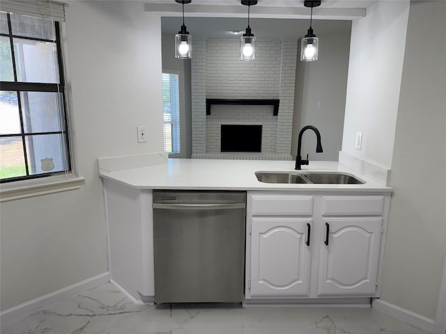 kitchen featuring dishwasher, white cabinetry, hanging light fixtures, and sink