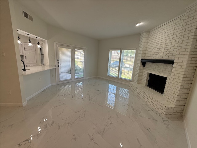 unfurnished living room with a brick fireplace