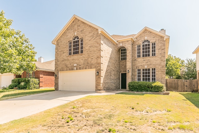 view of front of house featuring a garage and a front lawn