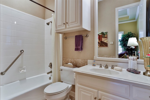 full bathroom featuring ornamental molding, vanity, toilet, and tiled shower / bath combo