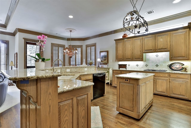 kitchen featuring dishwasher, light hardwood / wood-style flooring, a notable chandelier, a large island, and pendant lighting