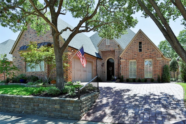 tudor-style house featuring a garage