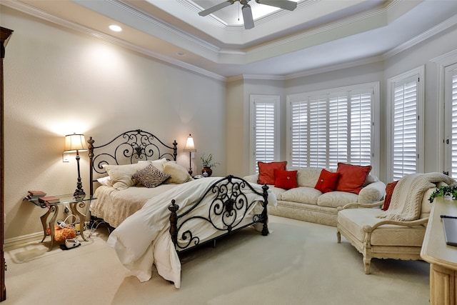 carpeted bedroom featuring crown molding, ceiling fan, and a tray ceiling