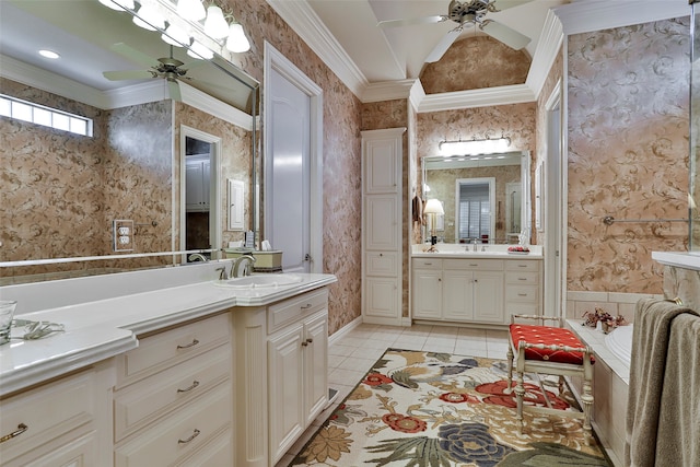 bathroom featuring tile patterned flooring, crown molding, vanity, ceiling fan, and a bathtub