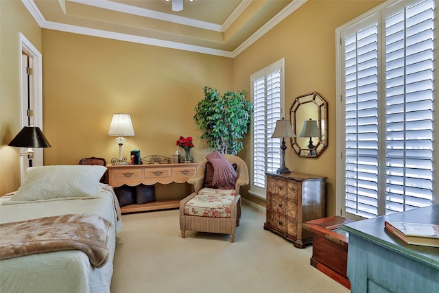 bedroom featuring crown molding, a tray ceiling, carpet floors, and multiple windows