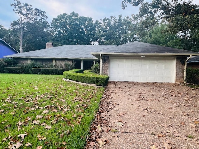 single story home featuring a garage and a front lawn