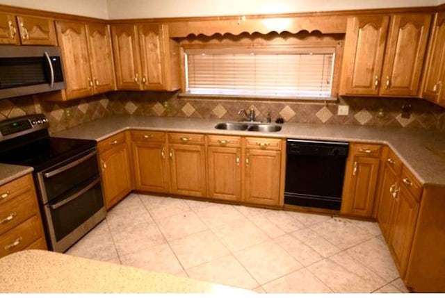 kitchen with appliances with stainless steel finishes, backsplash, and sink