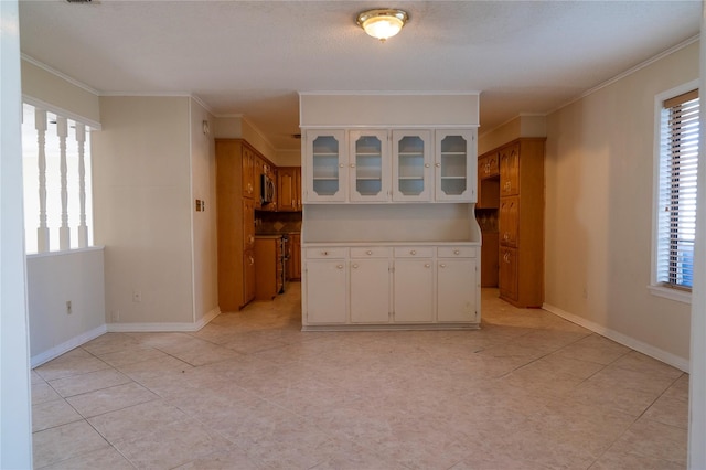 interior space with crown molding and white cabinetry