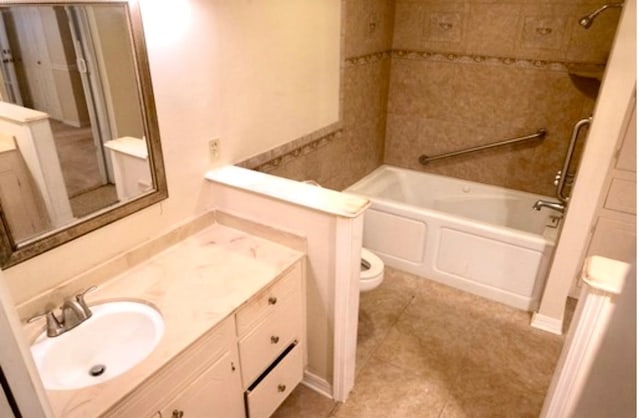 full bathroom with tile patterned floors, toilet, tiled shower / bath combo, and vanity