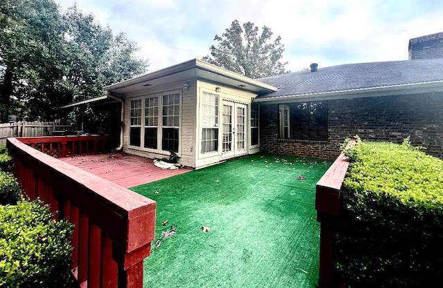 rear view of house featuring a wooden deck