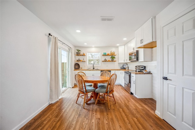 dining room featuring light wood-type flooring and sink