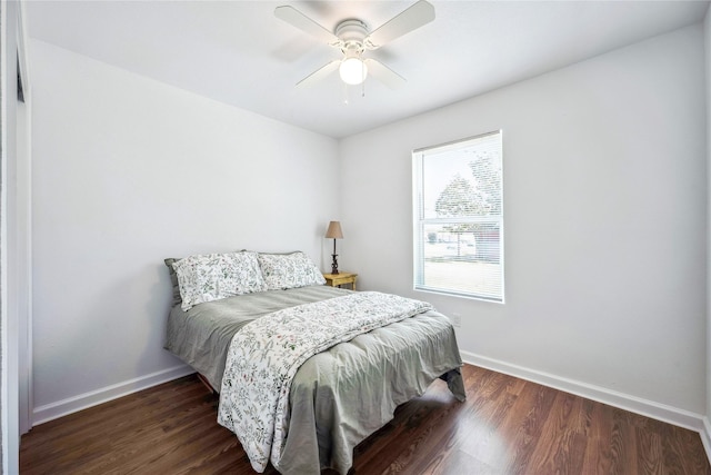 bedroom with ceiling fan and dark hardwood / wood-style flooring