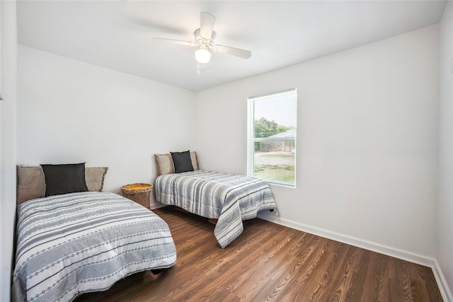 bedroom featuring ceiling fan and dark wood-type flooring