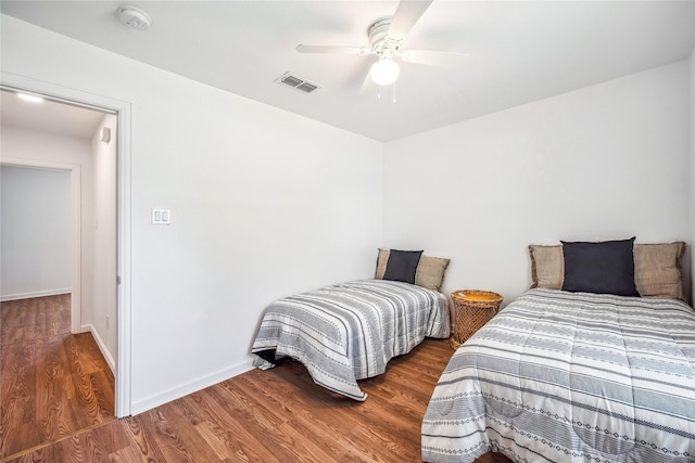 bedroom featuring ceiling fan and dark wood-type flooring