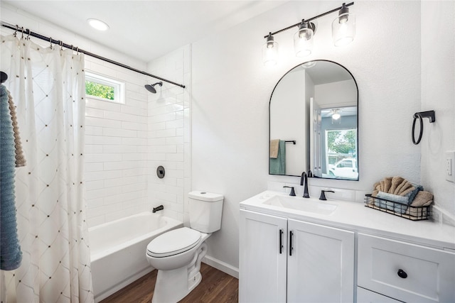 full bathroom featuring hardwood / wood-style flooring, shower / bath combination with curtain, toilet, and vanity