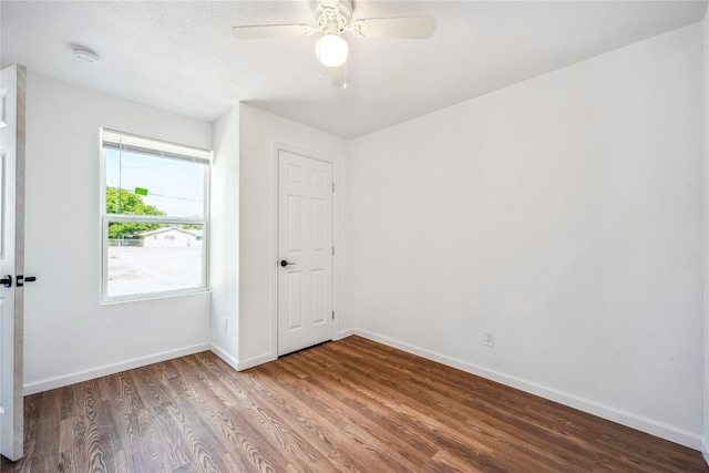 spare room with ceiling fan and wood-type flooring