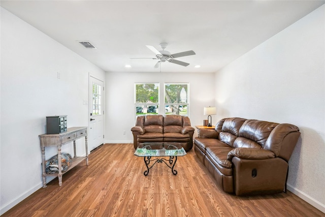 living room with ceiling fan and hardwood / wood-style flooring