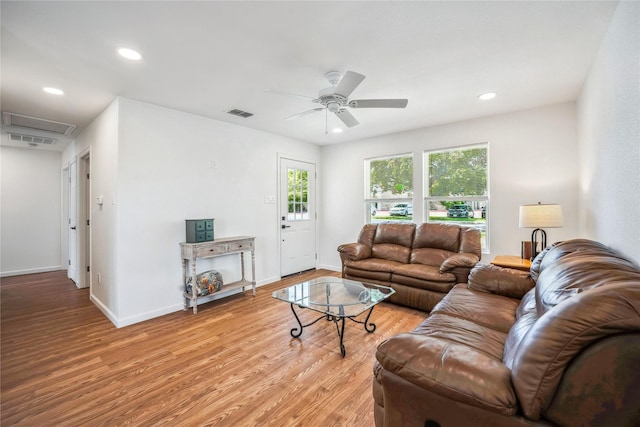 living room with light hardwood / wood-style floors and ceiling fan