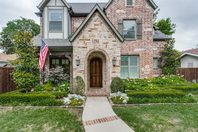 english style home with a front lawn