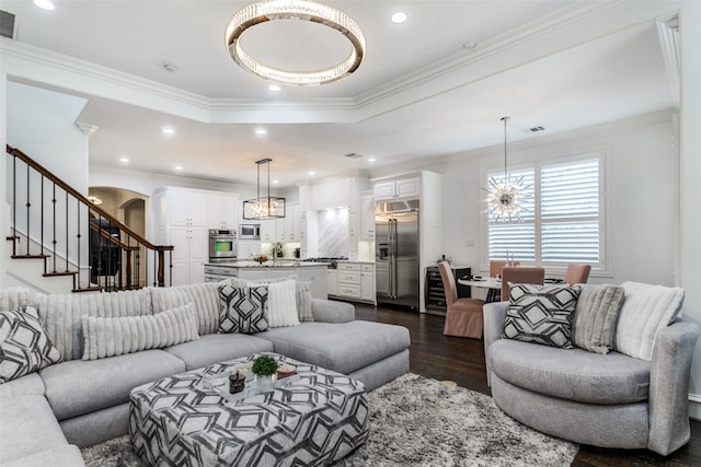 living room with crown molding, an inviting chandelier, and dark hardwood / wood-style flooring