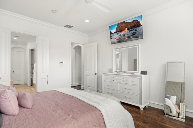 bedroom with ceiling fan, ornamental molding, and dark hardwood / wood-style floors