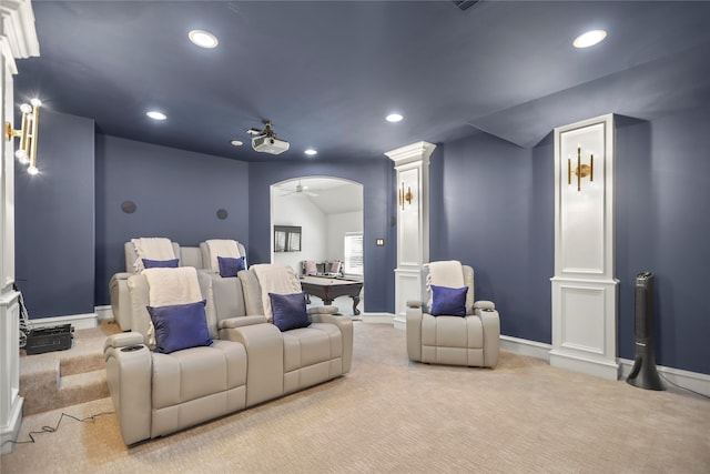 carpeted home theater featuring decorative columns and ceiling fan