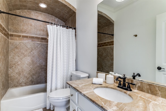 full bathroom featuring lofted ceiling, toilet, shower / bath combo with shower curtain, ornamental molding, and vanity