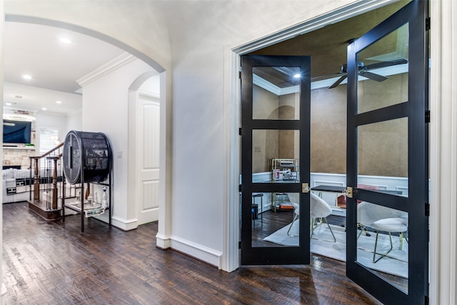 corridor featuring french doors, crown molding, and dark hardwood / wood-style flooring