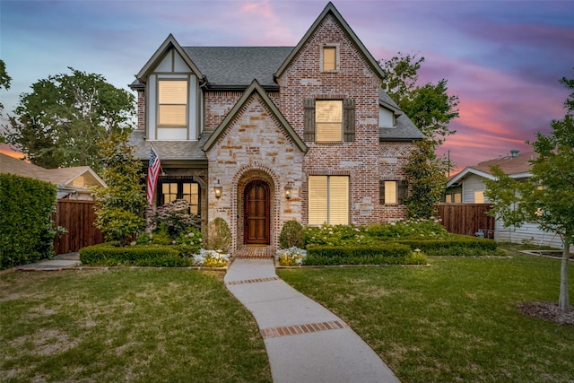 tudor home featuring a lawn