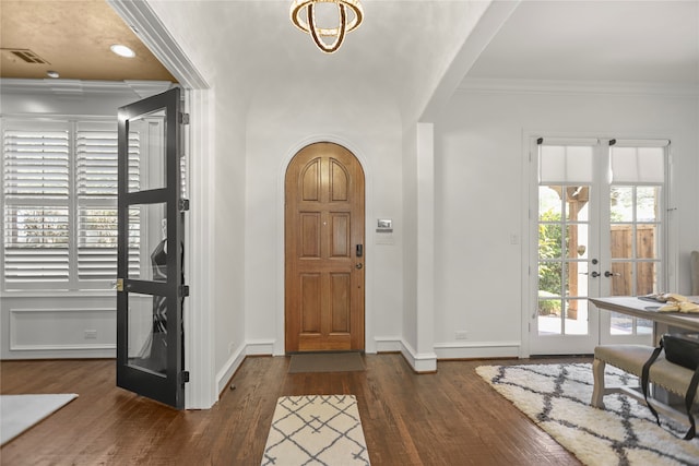 foyer with ornamental molding, french doors, and dark hardwood / wood-style floors