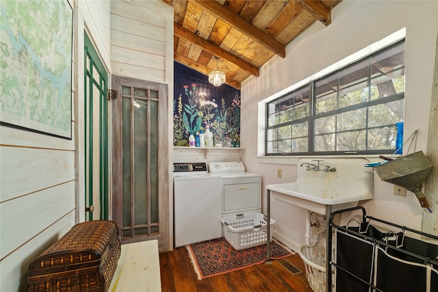 laundry room featuring wooden ceiling, dark wood-type flooring, and separate washer and dryer