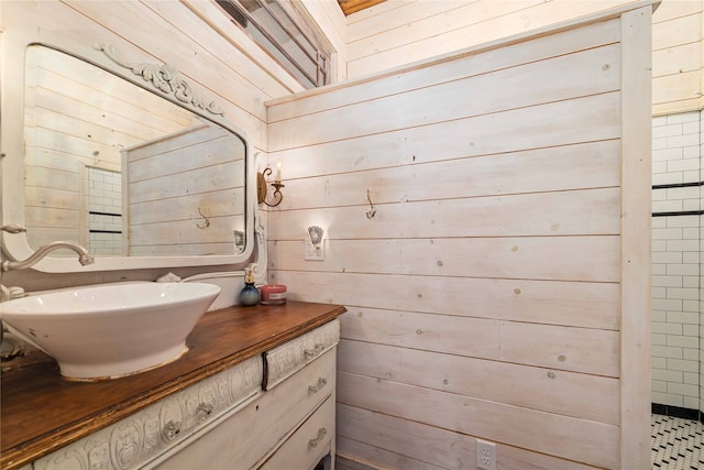 bathroom with vanity and wood walls