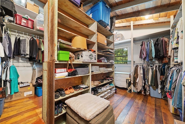 spacious closet with hardwood / wood-style floors and lofted ceiling with beams