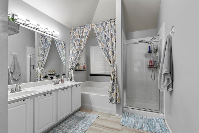 bathroom with hardwood / wood-style floors, shower with separate bathtub, and vanity