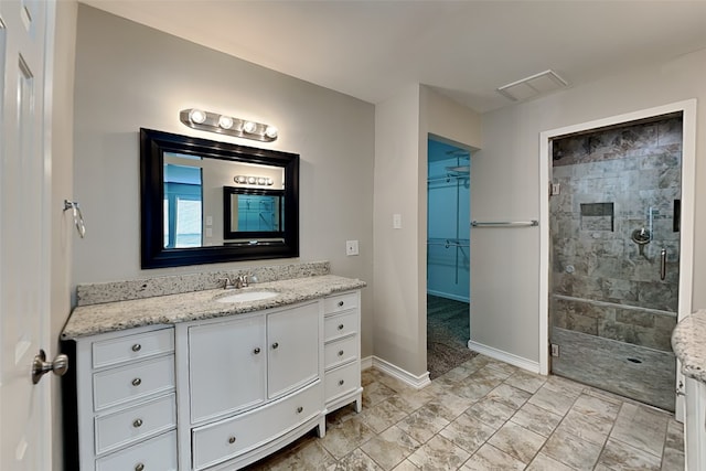 bathroom with walk in shower and vanity