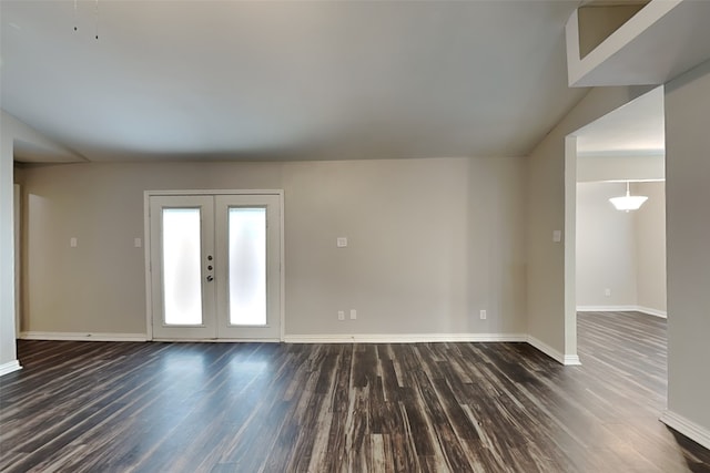 entryway with lofted ceiling, dark hardwood / wood-style floors, and french doors