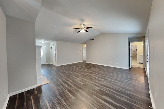 unfurnished living room featuring dark wood-type flooring, vaulted ceiling, and ceiling fan