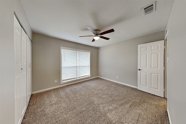 unfurnished bedroom with carpet flooring, ceiling fan, and a closet