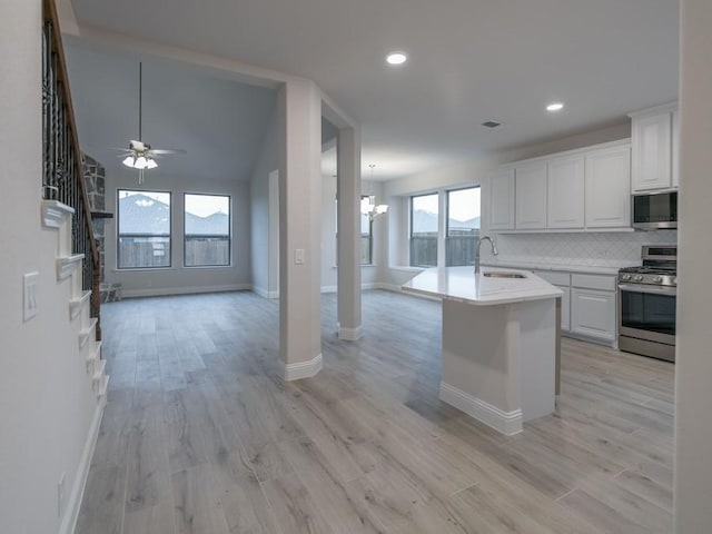 kitchen featuring white cabinets, stainless steel appliances, and a healthy amount of sunlight